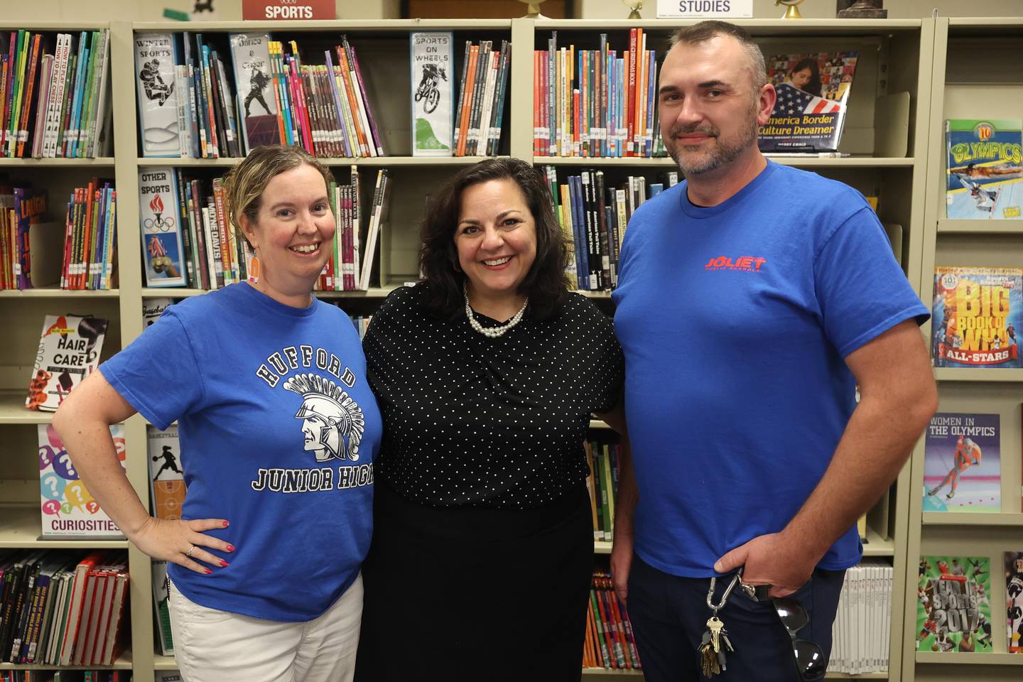 Judith Nash, center, stands with her former students Amanda Tancl and Evan Giardina at Hufford Junior High School in Joliet. Now, 31 years later, Tancl, Giardina and Nash work for District 86.