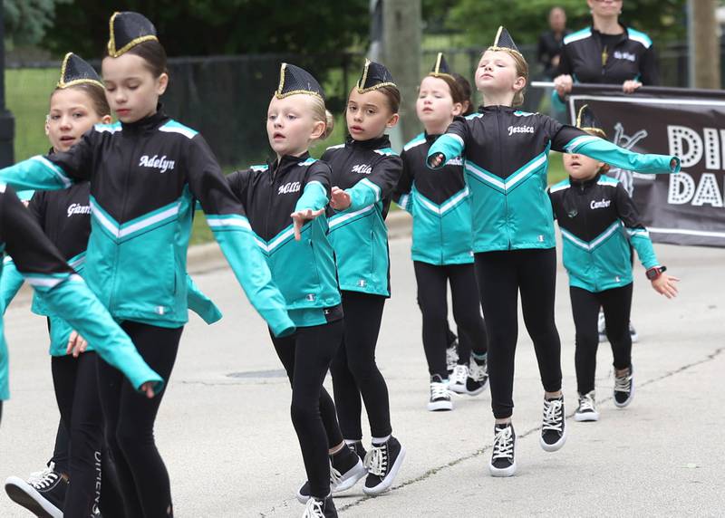 Members of Dimensions Dance Academy dance their way down West Locust Street during the DeKalb Memorial Day parade Monday, May 27, 2024, as it heads to Ellwood House where a ceremony was held wrapping up the day’s events.