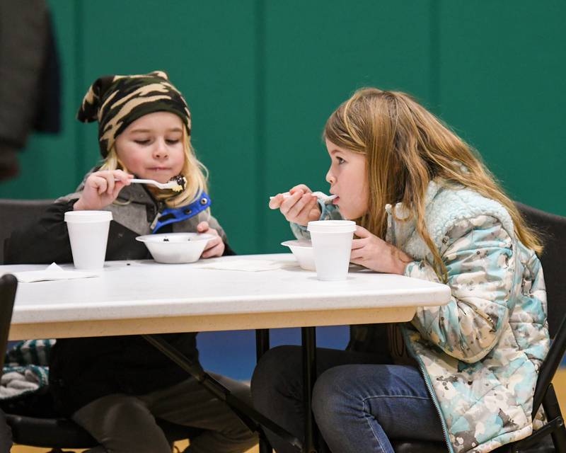 Ashton Kendall, left, 6, and Avery Kendall, 9, of Lilly Lake, enjoy some ice cream during the Sycamore Park District's Fire and Ice Festival held at Sycamore Park District Community Center on Saturday, Jan. 13, 2024.