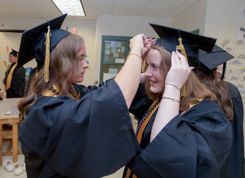 Kalli Fowler helps Lilly Faulhaber with her cap before the 2024 Sycamore High School commencement in Sycamore on Sunday, May 26, 2024.