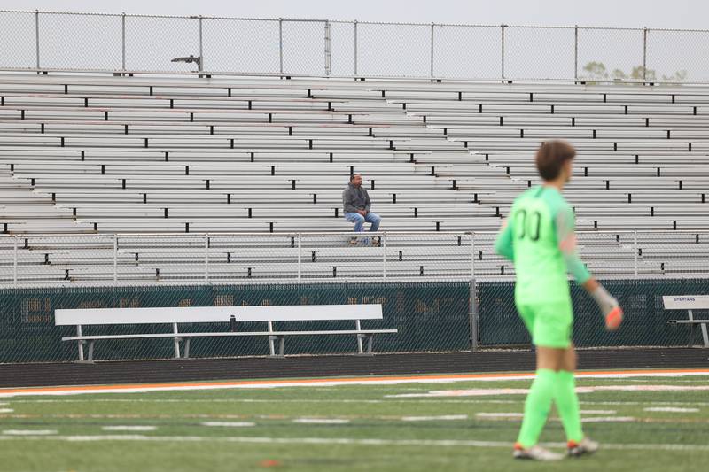 A fan sits alone on the visitor's side during the match between Joliet West and host Romeoville on Wednesday, Oct. 11, 2023 in Romeoville.