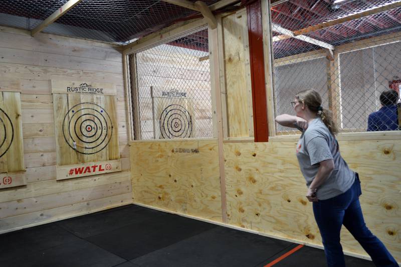 Tonya Hardy, of Oregon, throws an ax during the grand opening of Rustic Ridge Axe Throwing on May 28. The business is located at 117 N. 4th St., Oregon, and is affiliated with the World Axe Throwing League.