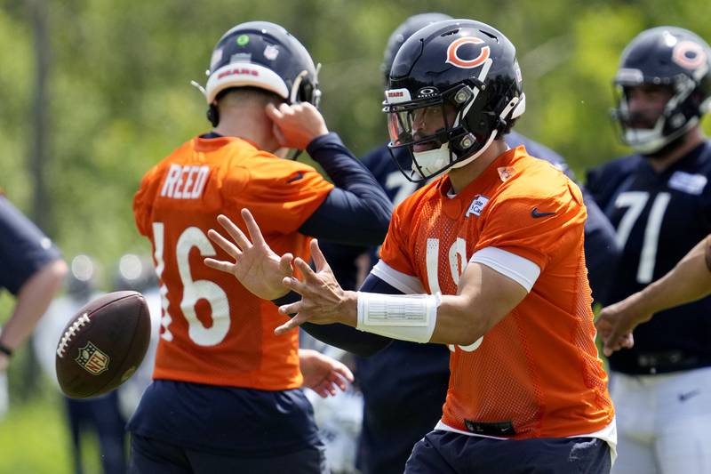 Chicago Bears quarterback Caleb Williams works on the field with teammates during NFL football practice in Lake Forest, Ill., Friday, May 31, 2024. (AP Photo/Nam Y. Huh)