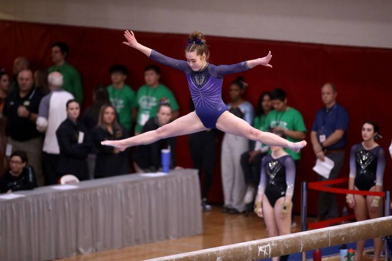 Downers Grove South’s Edith Condon competes on the balance beam during the IHSA Girls State Gymnastics Meet at Palatine High School on Friday, Feb. 16, 2024.