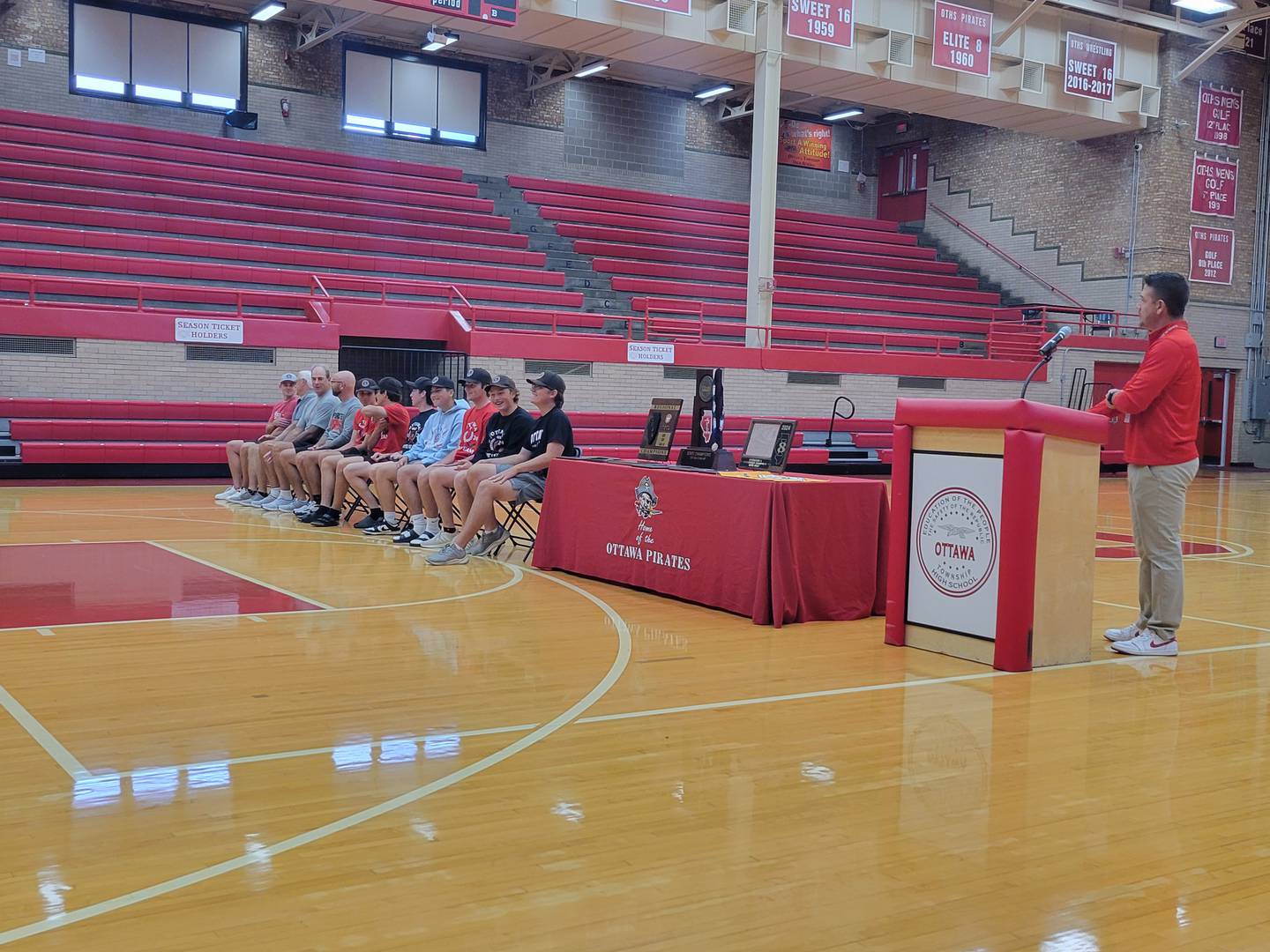 Ottawa athletic director Jon Leslie begins Sunday's ceremony at Kingman Gym honoring the Pirates Class 2A champion boys golf team.