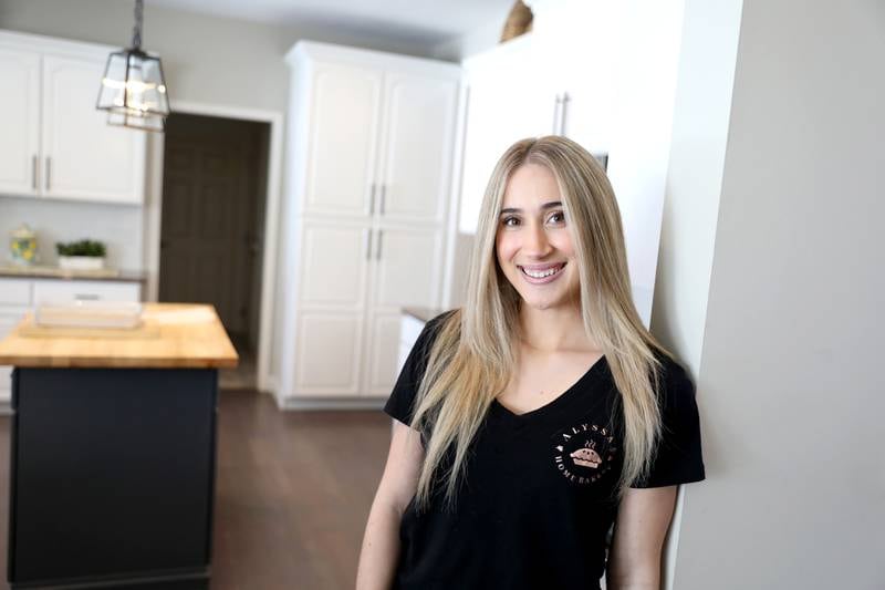 Alyssa Altman, 20, makes cookies for a gender reveal party in the kitchen of her Geneva home. Altman started a cookie business during the Covid-19 pandemic when she was a junior in high school. Now a junior at Northern Illinois University, she continues to bake.