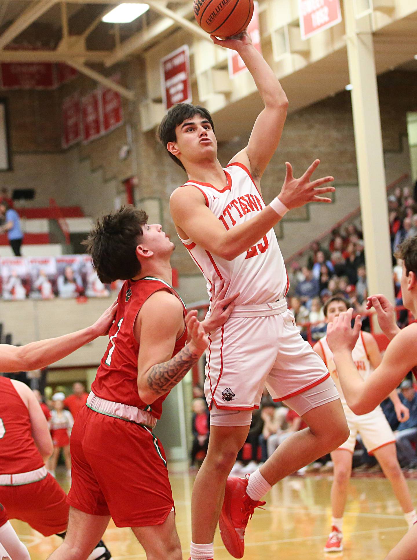 Ottawa's Payton Knoll runs into the lane past L-P's London Cabrera to score on a layup in Kingman Gymnasium on Friday, Feb. 10, 2023 at Ottawa High School.