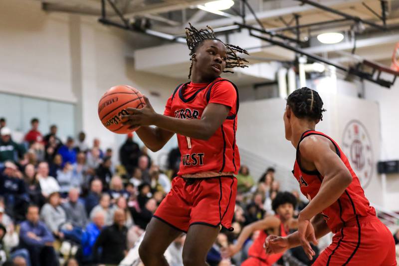 West Aurora's Donta'e Woods (1) grabs a rebound during Class 4A Lockport Regional final game between West Aurora at Oswego East.  Feb 24, 2023.