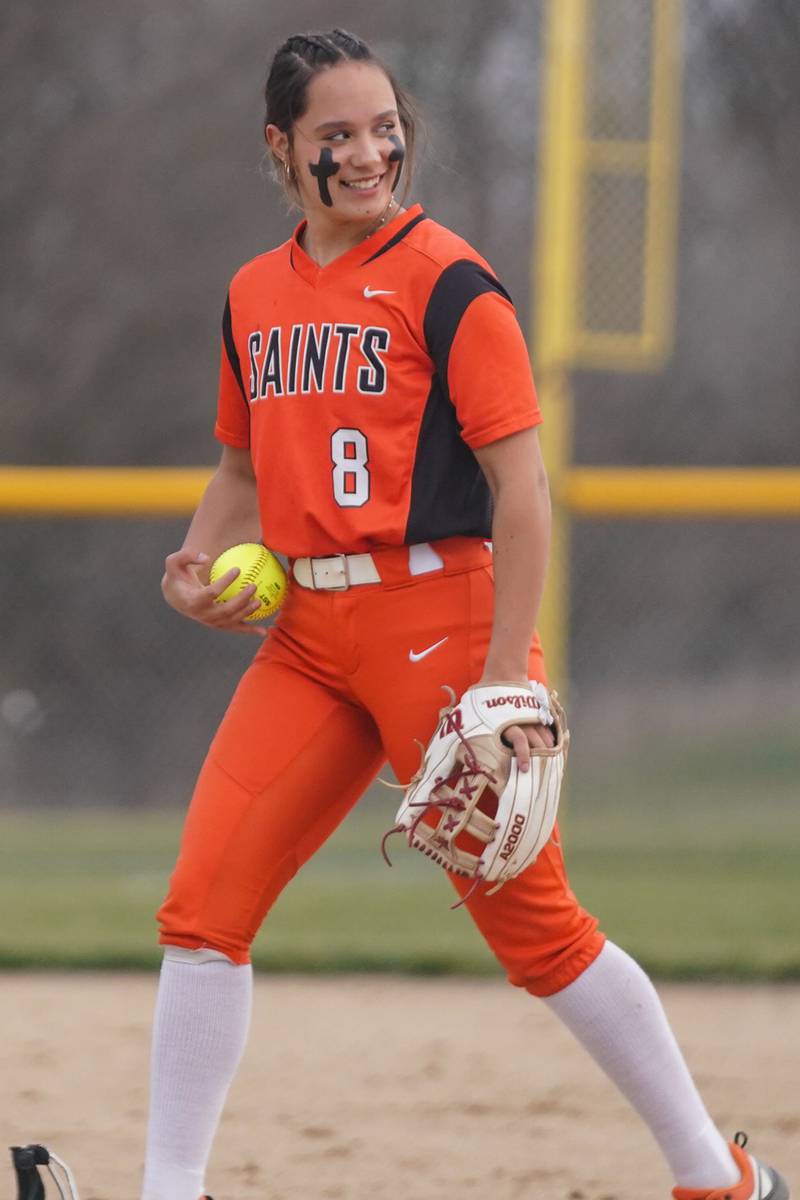 St. Charles East's Grace Hautzinger (8) smiles as she takes the pitcher’s circle against Oswego East during a softball game at Oswego East High School on Wednesday, March 13, 2024.