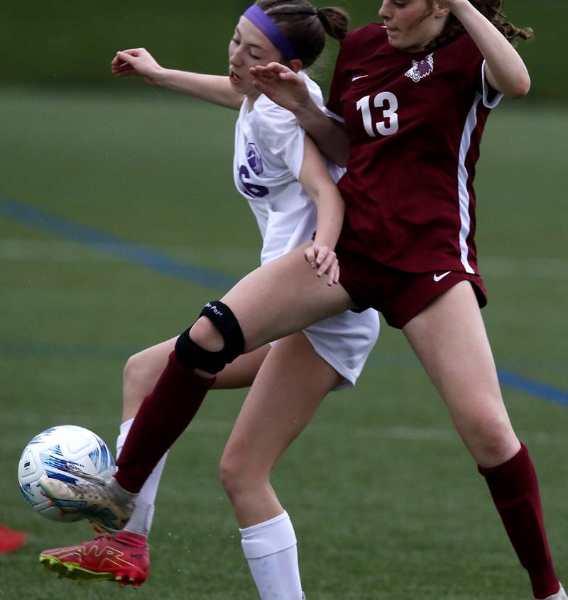 Hampshire's Langston Kelly battles with Prairie Ridge's Emily McPherson for control of the ball during a Fox Valley Conference soccer game on Tuesday, April 16, 2024, at the MAC Athletic Complex in Crystal Lake.