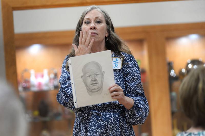 Retired forensic artist Bethe Hughes of Dixon talks about how to draw suspects during a workshop on forensic art at the Coliseum Museum of Art, Antiques, and Americana in Oregon on Saturday, Aug. 17, 2024. Hughes worked as a special agent for the Illinois State Police for 20 years before retiring.