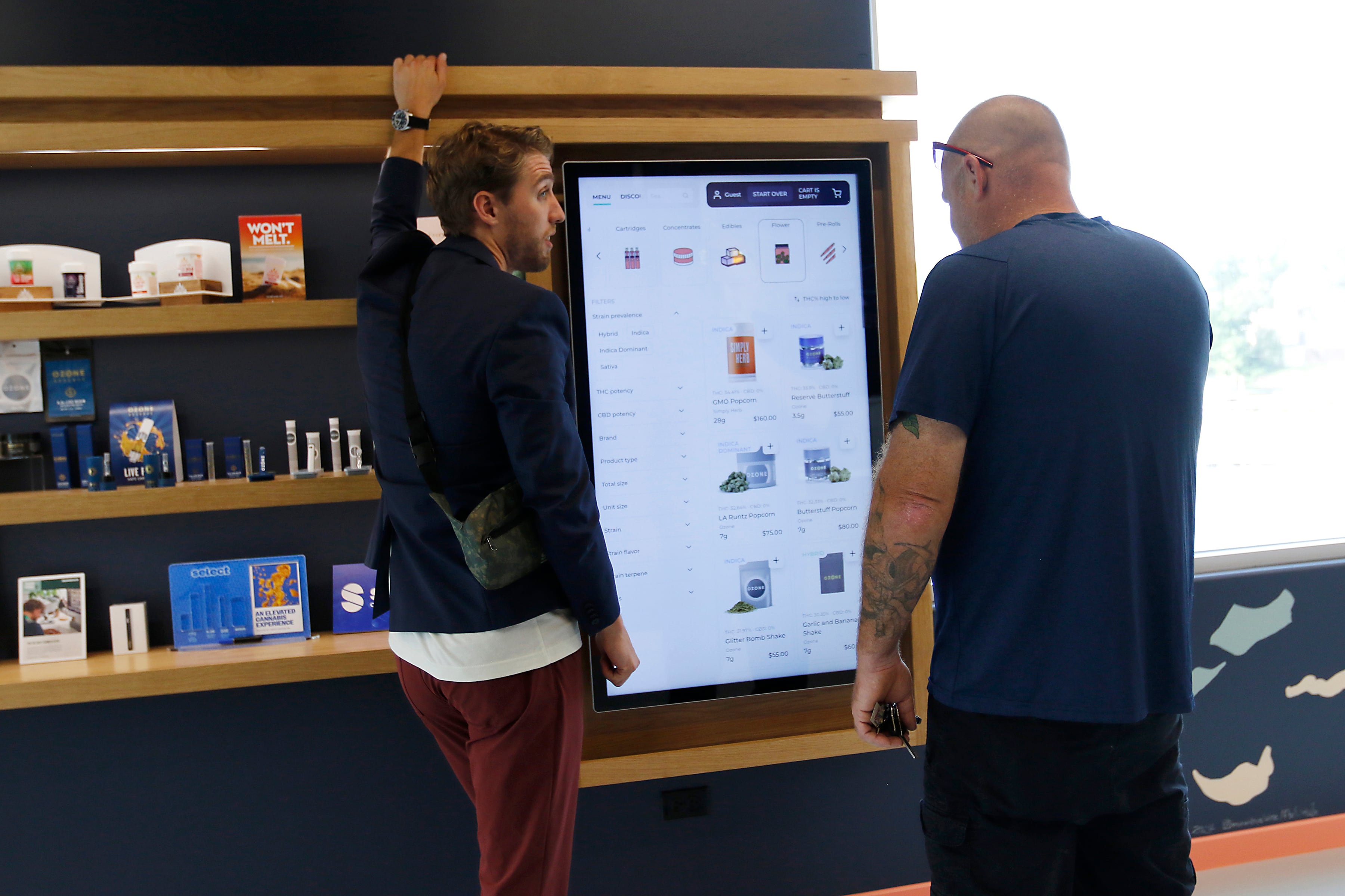 Smokehouse General Manager Zach Edgerton helps a customer at Illinois’ first dispensary located right on the water in Fox Lake on Friday, July 25, 2024. The dispensary located at 44 U.S. Route 12, features boat slips so customers on the Fox River and Chain o' Lakes can boat right up to the dispensary.