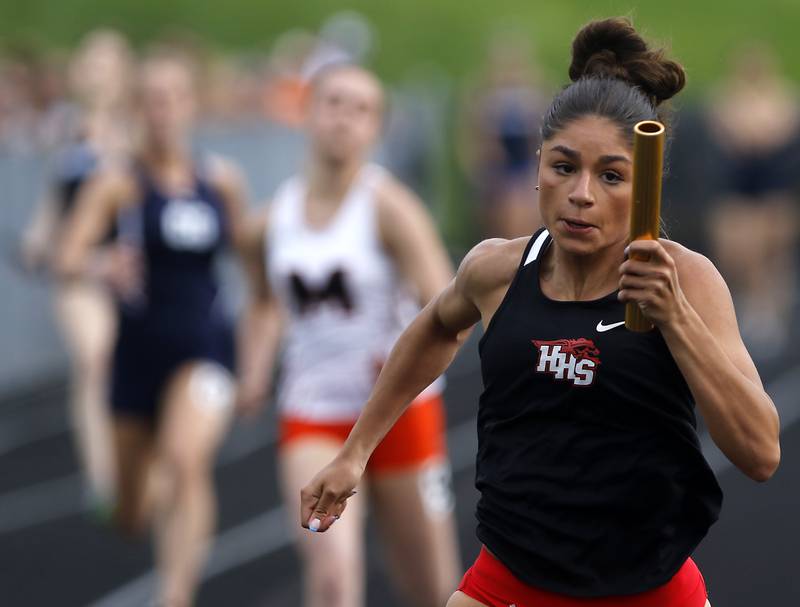 Huntley’s Victoria Evtimov flies to the finish line as she races the final leg of the 4 x 100 meter relay on Thursday, May 2, 2024, during the Fox Valley Conference Girls Track and Field Meet at Jacobs High School in Algonquin.