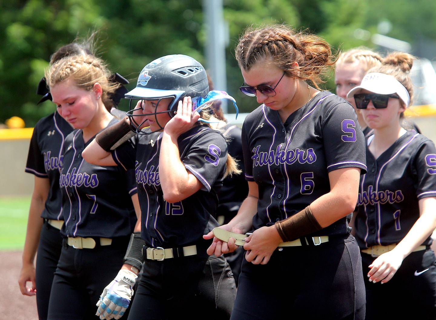 The Serena Huskers softball team walks toward its dugout to line up for the postgame awards ceremony after a 5-2, extra-inning loss to Villa Grove in the Class 1A Illinois Weselyan Supersectional on Monday, May 27, 2024, in Bloomington.