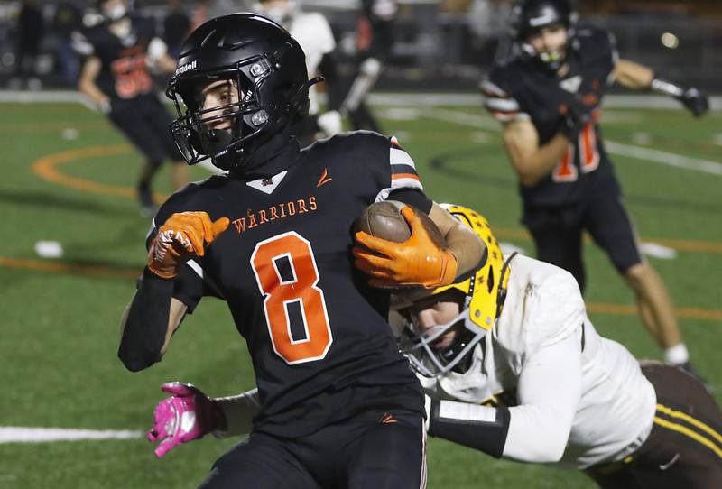 McHenry's Jeffry Schwab is tackled by Jacobs' Matthew Scardina during a Fox Valley Conference football game on Friday, Oct. 18, 2024, at McKracken Field in McHenry.