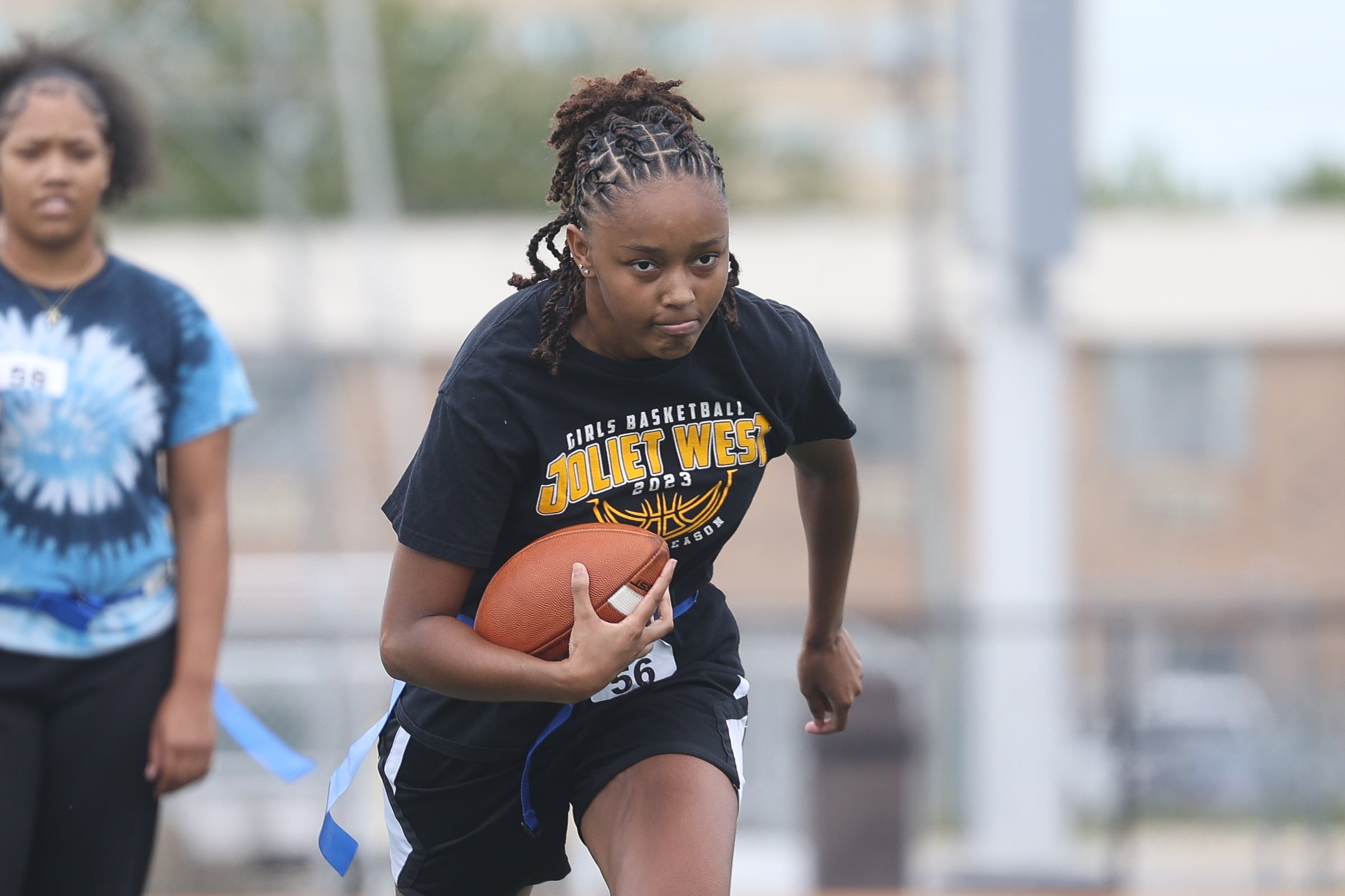 Tamia Saunders runs a drill during Joliet West’s girls flag football tryouts on Monday, Aug. 12, 2024 at Joliet West High School.