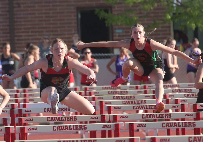 L-P's Elli Sines wins the 100 meter hurdles as teammate Aubrey Duttlinger jumps behind during the Interstate 8 conference track meet on Friday, May 3, 2024 at the L-P Athletic Complex in La Salle.