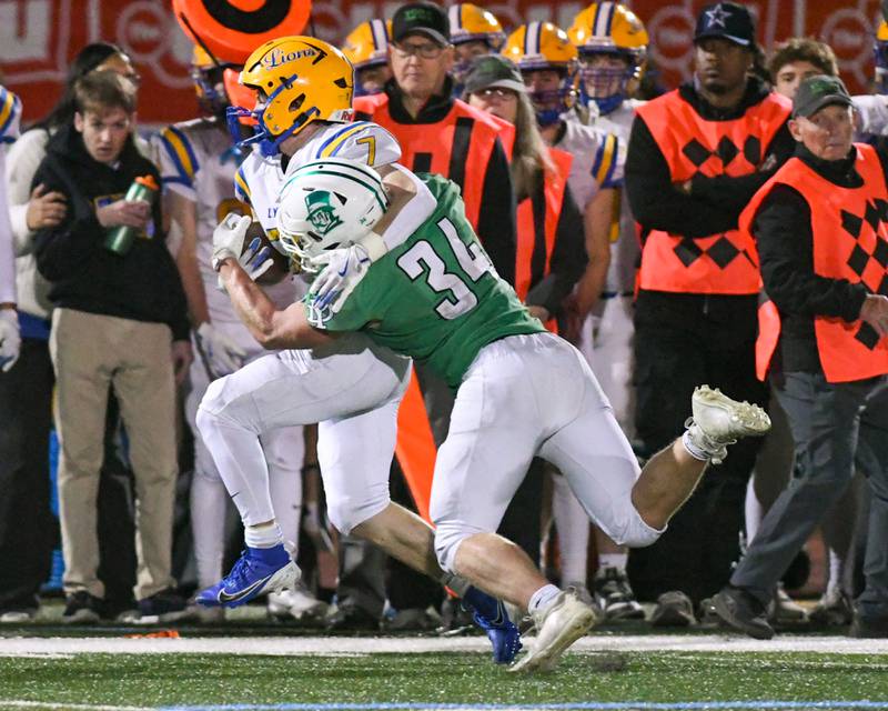 Lyons Township's Danny Carroll (7) gets pushed out of bounds by York’s Jesse Ryburn (12) on Friday Oct. 18, 2024, held at York High School in Elmhurst.