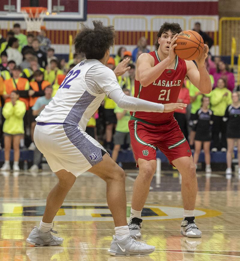 LaSalle-Peru’s Josh Senica looks to make a play against Dixon’s Darius Harrington Wednesday, Feb. 21, 2024 at the Sterling class 3A basketball regional.