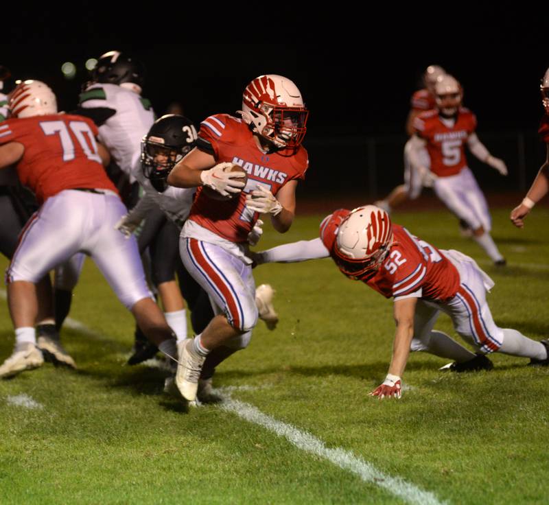 Oregon's Logan Weems (7) sidesteps a defender as Noah Hodges (52) blocks during a Friday, Oct. 6, 2023 game with Rock Falls at Oregon High School's Landers-Loomis Field.