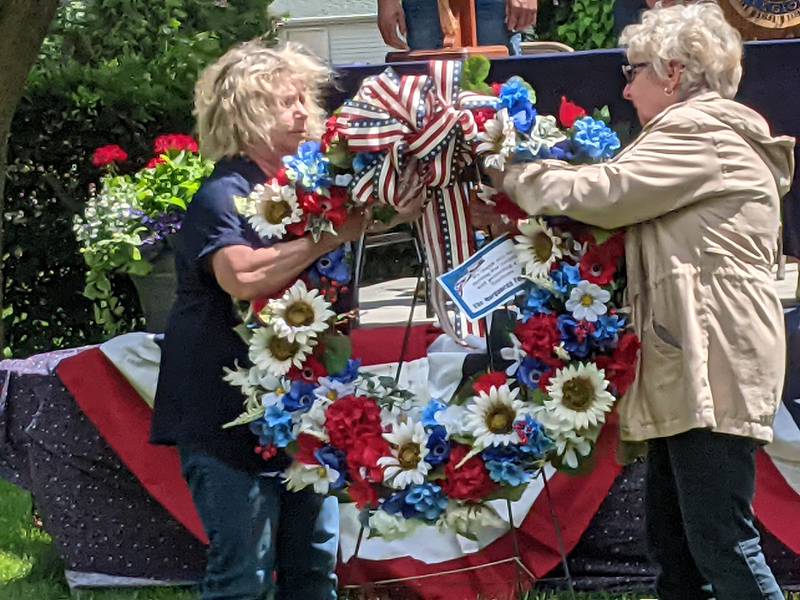 Yorkville American Legion Auxiliary President Diane Dillow, left, and Yorkville American Legion Auxiliary Chaplain Bonnie Havelka, right, put up a wreath at the Yorkville American Legion’s Memorial Day ceremony on May 27 at Town Square Park in Yorkville in honor of those who made the ultimate sacrifice.