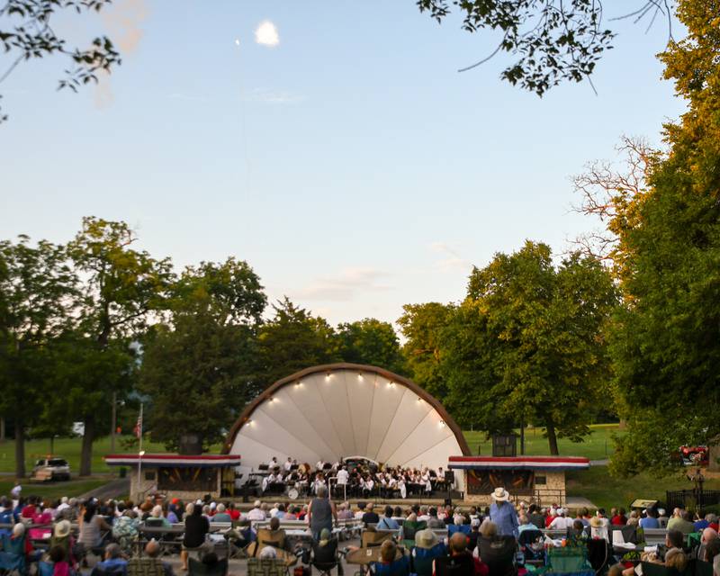 Community members all around DeKalb area gather to listen to the DeKalb Municipal Band play the 1812 overture while fireworks go off during the performance at Hopkins Park in DeKalb for the 4th of july festivities on Tuesday July 4, 2023.