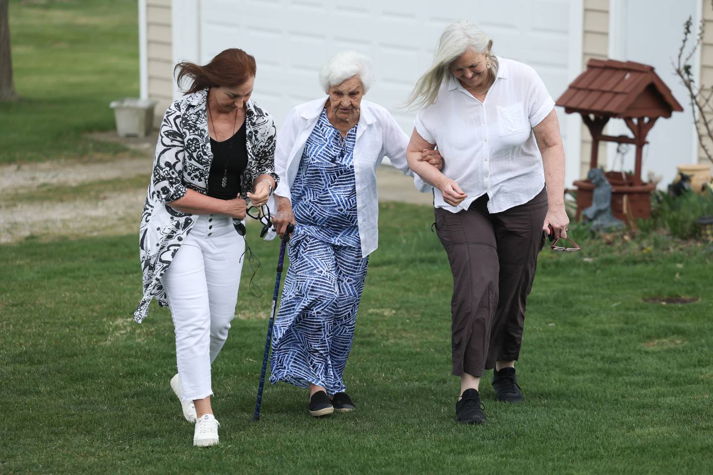 Diane Spangler-Ramirez (left) walks with her mother Dolores Spangler, 95 years old, along with her sister Debbie Cooper at Dolores’ home on Saturday, April 15, 2023 in Homer Township.