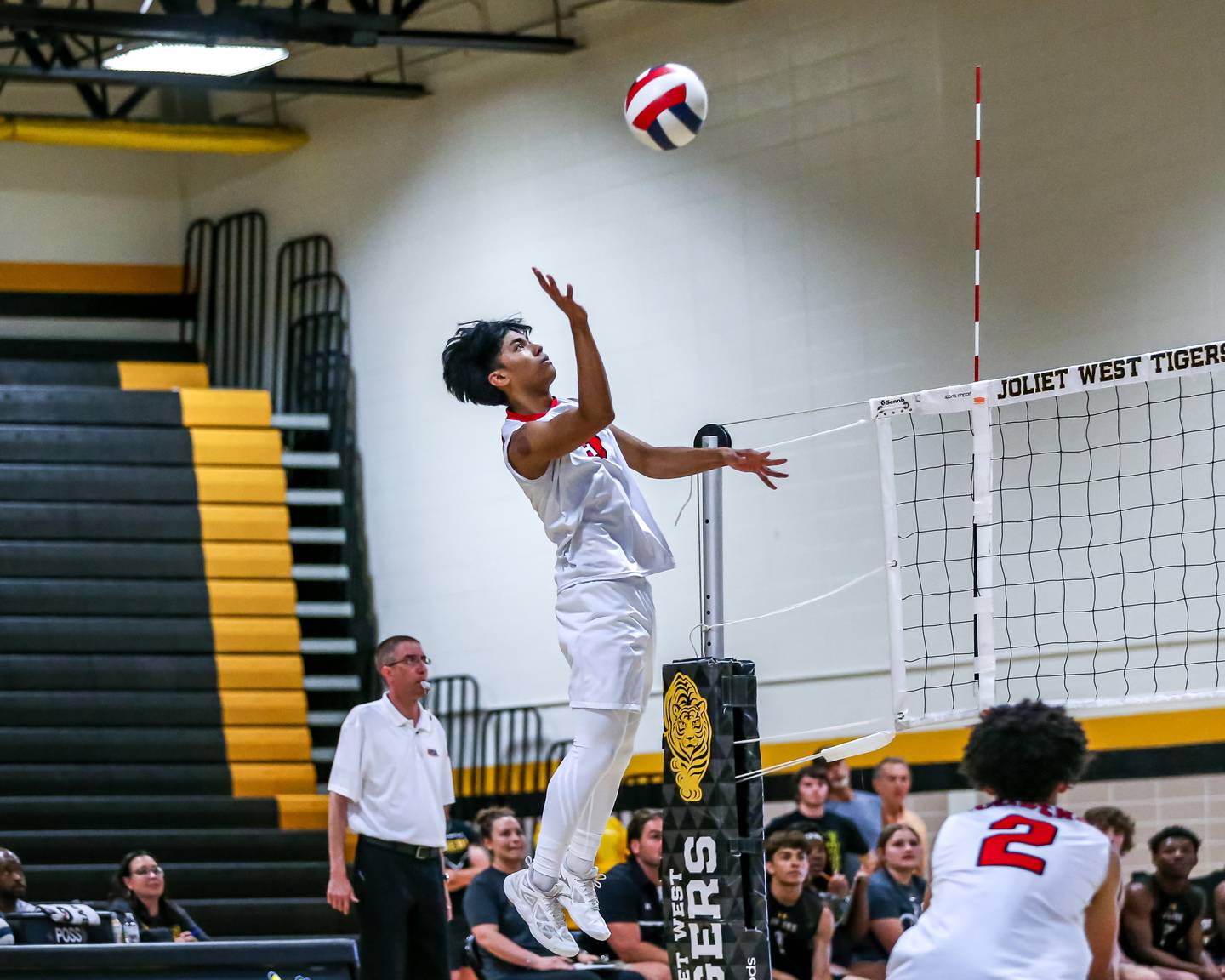 Bolingbrook's Tristan Caminar (5) tips the ball over the net during Joliet West Regional Championship match between Bolingbrook at Joliet West.  May 23, 2024.