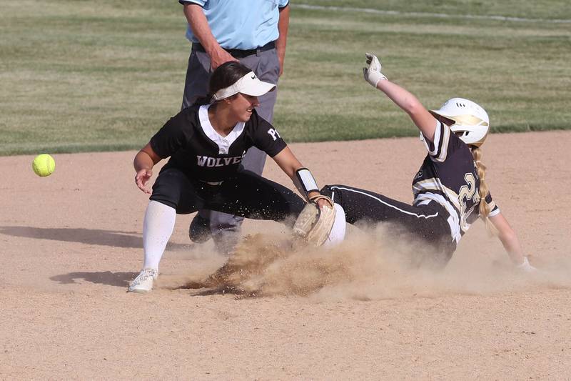 Sycamore's Keera Trautvetter slides in safely as Prairie Ridge's Emily Harlow can’t corral the ball during their Class 3A sectional final Friday, May 31, 2024, at Sycamore High School.