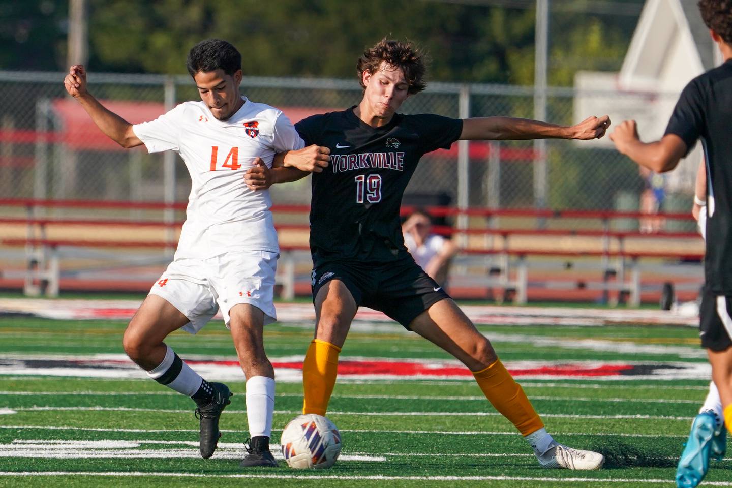 Oswego’s Julian Lopez (14) challenges Yorkville's Kyle Nadler (19) for the ball during a soccer match at Yorkville High School on Tuesday, Sep 17, 2024.