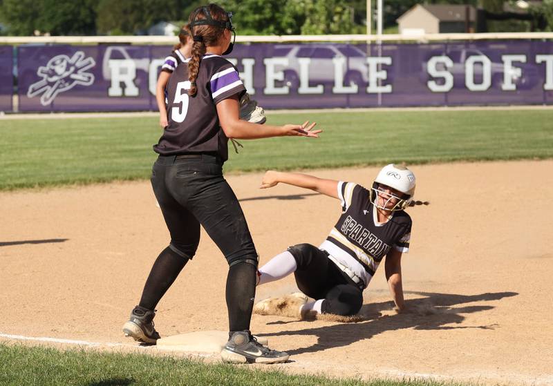 Sycamore's Addison Armstrong slides into third as Dixon's Elly Brown waits for the throw during their Class 3A regional championship game Thursday, May 23, 2024, at Rochelle High School.