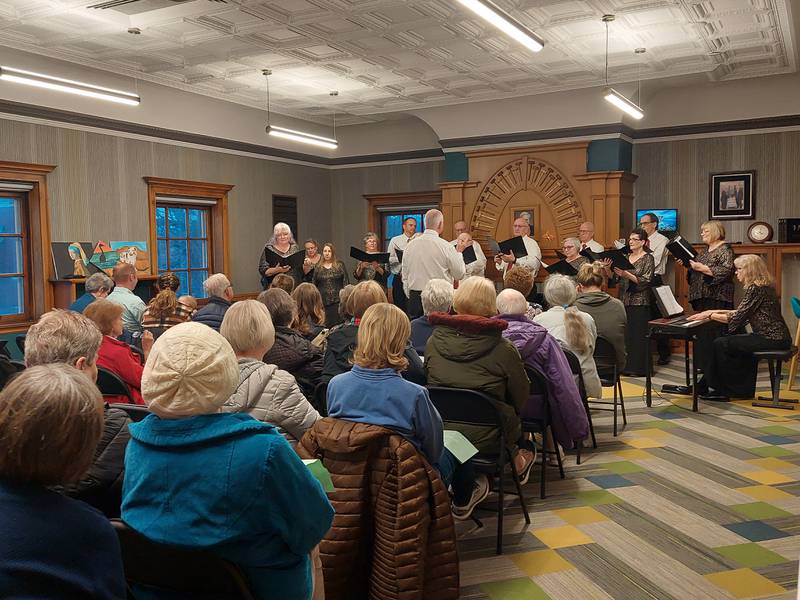 A crowd of people watch the Prairie Singer perform Tuesday, April 2, 2024, at the Streator Public Library.