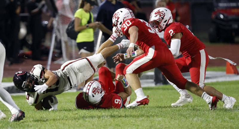 Barrington's Jacob Dorn (13) dives for extra yards as South Elgin's Vinny Tusa brings him down Friday, Aug. 30, 2024 in South Elgin.