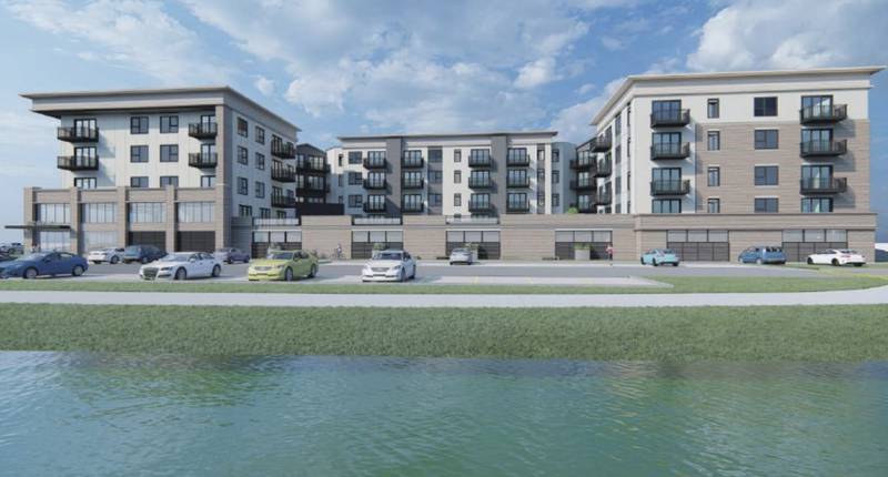 The rendering of a five-story, 114-unit apartment building as it would look facing River Lane and the Fox River. Benchmark Developers also propose 12 townhouses for the 1.2 acres of a city block in the Geneva Historic District.