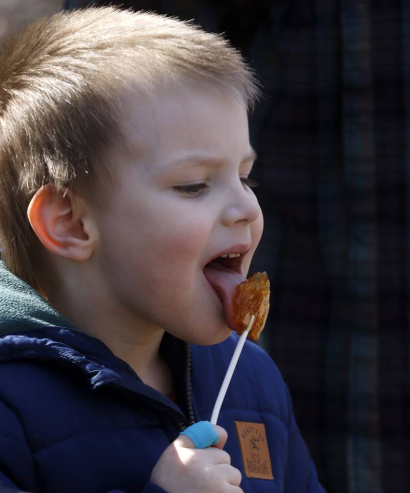 Sylvan Burrow, 5, of McHenry, enjoys a maple syrup sucker during the McHenry County Conservation District’s annual Festival of the Sugar Maples on Monday, March 6, 2023, at Coral Woods Conservation Area in Marengo.