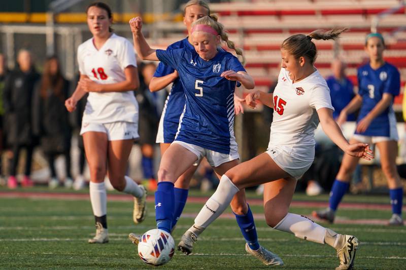 Glenbard East's Hope McKenna (15) challenges Geneva’s Audrey Stredde (5) for the ball during a Class 3A Glenbard East Regional semifinal soccer match at Glenbard East High School in Lombard on Tuesday, May 14, 2024.