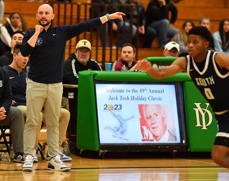 Downers Grove South head boys basketball coach Zach Miller directs his team during a Jack Tosh Classic game against on Dec. 26, 2023 at York High School in Elmhurst.