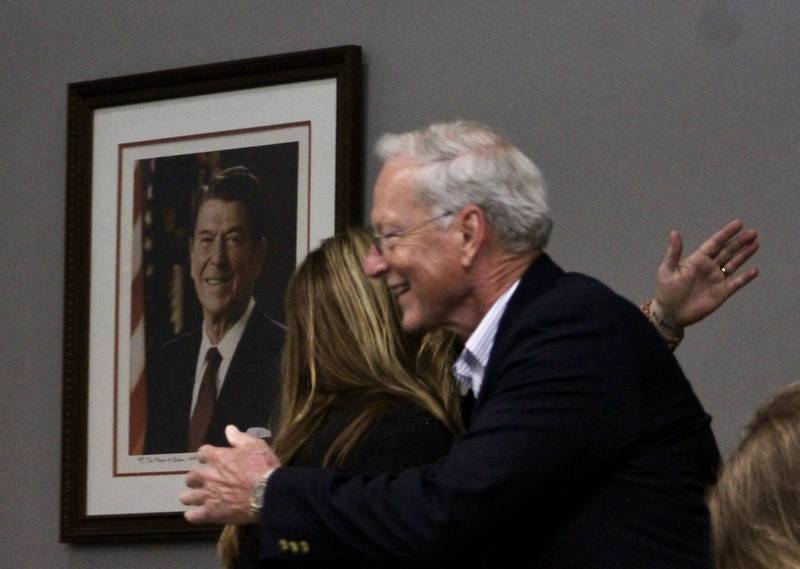 Mayor Glen Hughes embraces Council Member Mary Oros after he takes the oath of office on Monday, May 1, 2023. Moments later Oros would be the first council member that Hughes swears in.