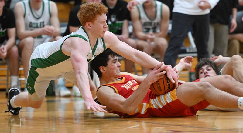 York’s Ryan Pechous, left, and Batavia’s C.J. Valente go to the floor for the ball during the Addison Trail Class 4A boys basketball sectional semifinal on Wednesday, Feb. 28, 2024 in Addison.