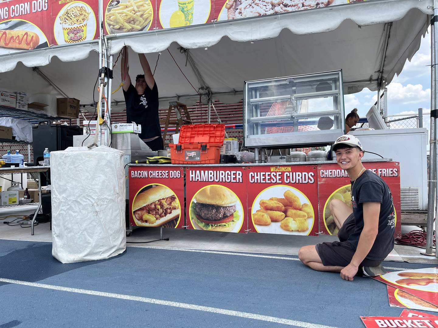 Sal Memeti (right), manager of Barone's Pizza of Countryside, sets up the food vendor stand for the restaurant on Thursday, June 20, ahead of the Taste of Joliet at Joliet Memorial Stadium in Joliet.