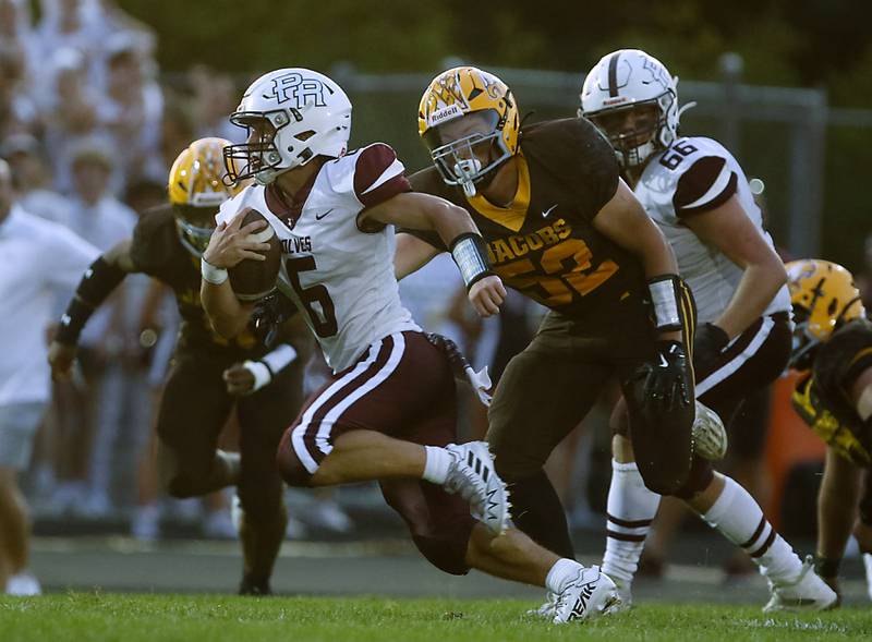 Prairie Ridge's Luke Vanderwiel runs away from Jacobs' Tyler Genger as he returns a punt during a Fox Valley Conference football game on Friday, Aug 30, 2024, at Jacobs High School in Algonquin.