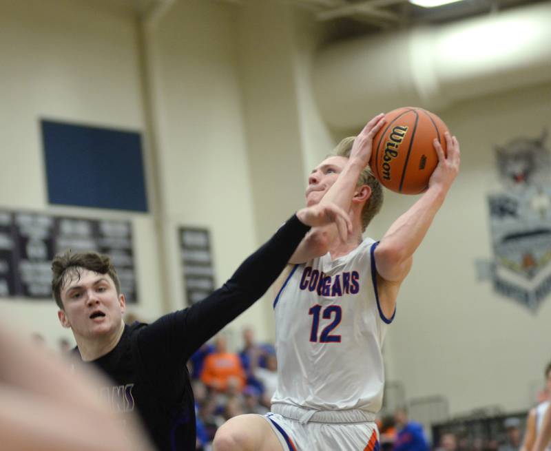 Eastland's Adam Awender (12 )draws contact as he drives to the basket against Pecatonica during the championship game of the 1A River Ridge sectional on Friday, March 1, 2024.