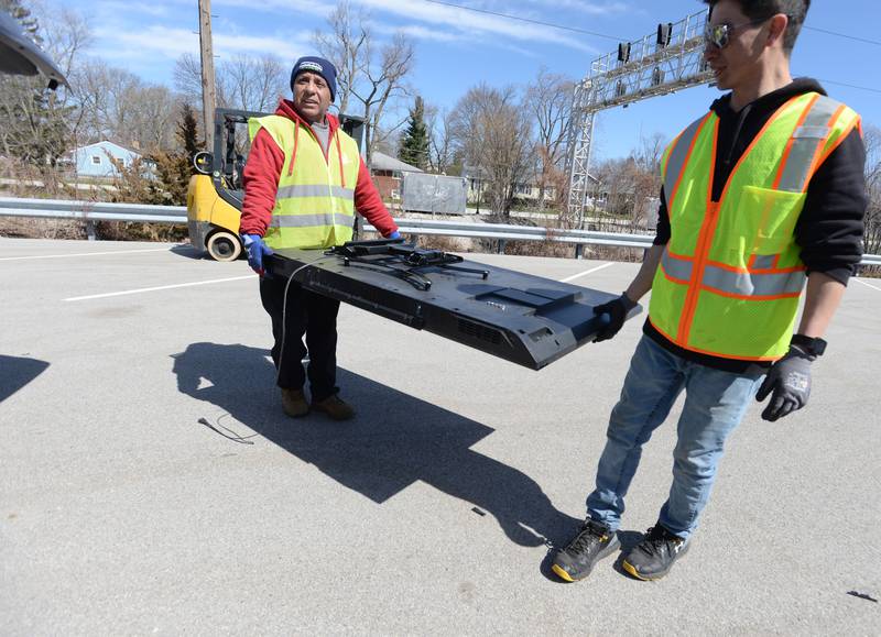 eWorks employees (left) Arturo Arzate and Mynor Velasquez take recycle a used television during the Electronics and More Recycling event held in Westmont Saturday, April 6, 2024.