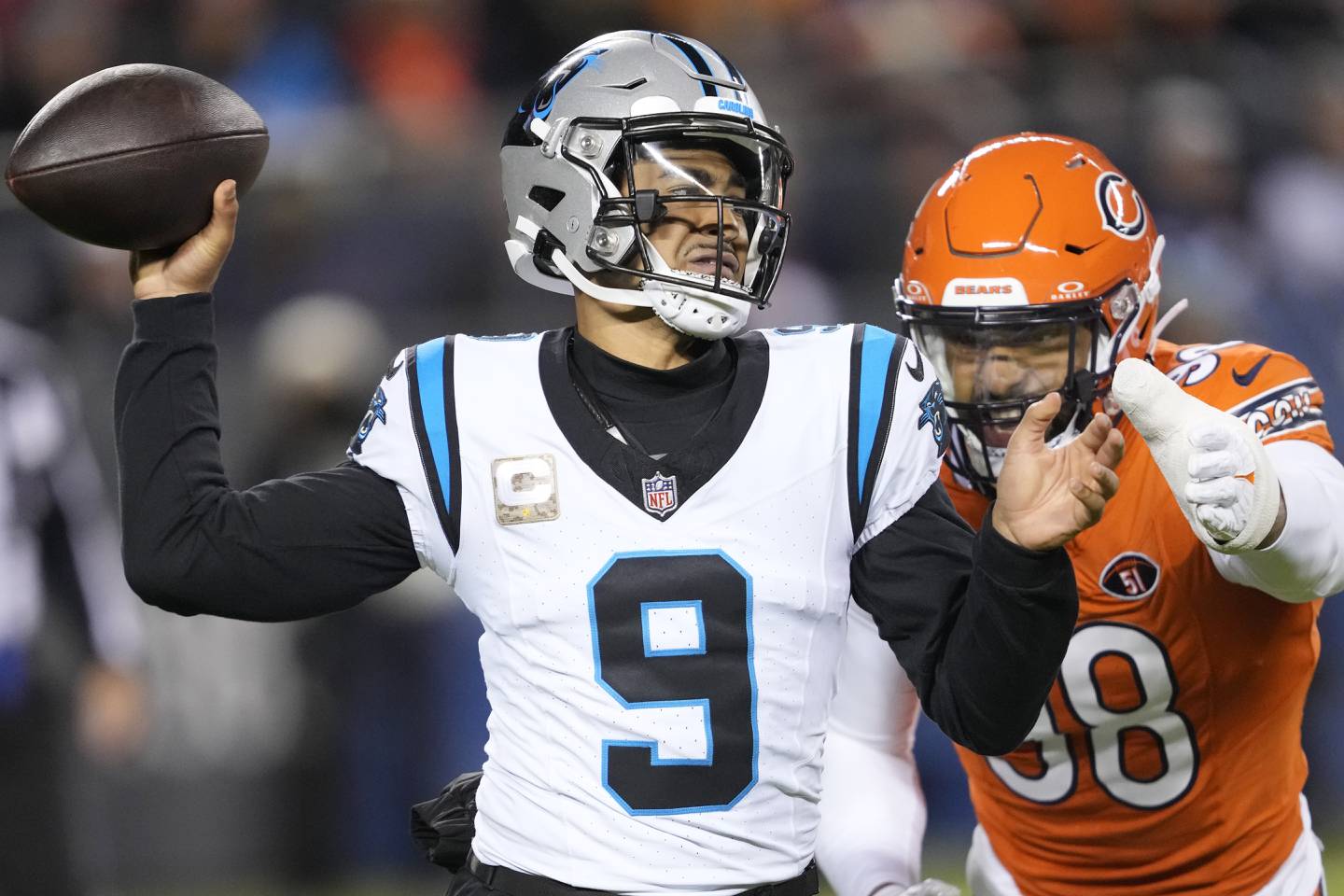 Carolina Panthers quarterback Bryce Young (9) throws under pressure from Chicago Bears defensive end Montez Sweat (98) during the first half of an NFL football game Thursday, Nov. 9, 2023, in Chicago.