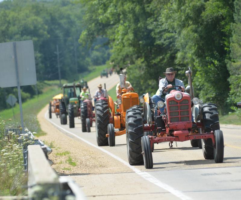 Tractors travel north on Daysville Road during the Living History Antique Equipment Association's tractor drive on Saturday. About 40 tractors took part in the ride that started at the association's show grounds in Franklin Grove and traveled to Oregon and back.