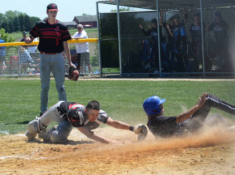 Forreston catcher Mikey Probst reaches to try and tag East Dubuque's Angel Reyes, but Reyes beats the throw to score the winning run in the championship game of the 1A  Forrestion Sectional on Saturday, May 25, 2024 at Forreston High School. East Dubuque scored two runs in the top of the seventh inning to edge the Cardinals 4-3 and move on to the supersectional.