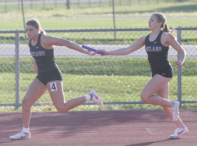 Kaneland's Brooke Pfeiffer and Elizabeth Eberhardt run in the 4x200 relay during the Interstate 8 conference track meet on Friday, May 3, 2024 at the L-P Athletic Complex in La Salle.