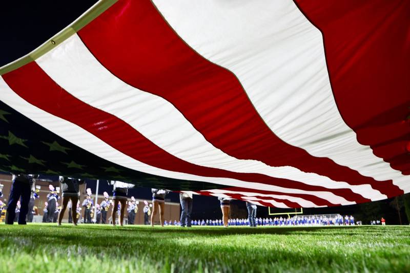 The Stars and Stripes were on displaying during the playing of the National Anthem on Friday night at Bryant Field.