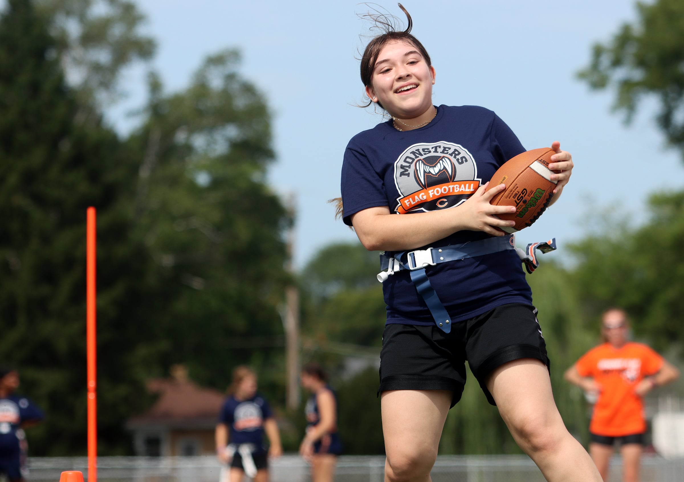 Jacobs High School freshman Naema Straukas runs the ball as the Chicago Bears and McHenry Community High School hosted a flag football clinic at McCracken Field Wednesday, July 31, 2024.