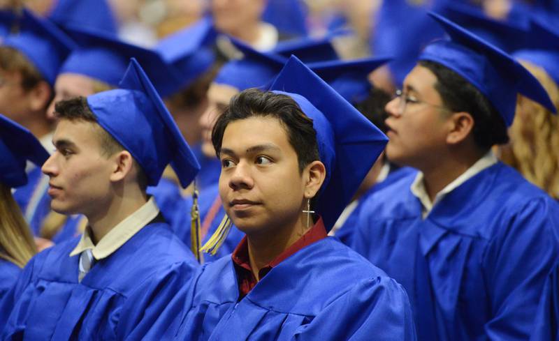 Joe Lewnard/jlewnard@dailyherald.com
Graduates watch the Wheaton North High School graduation ceremony, held at the College of DuPage in Glen Ellyn Saturday.